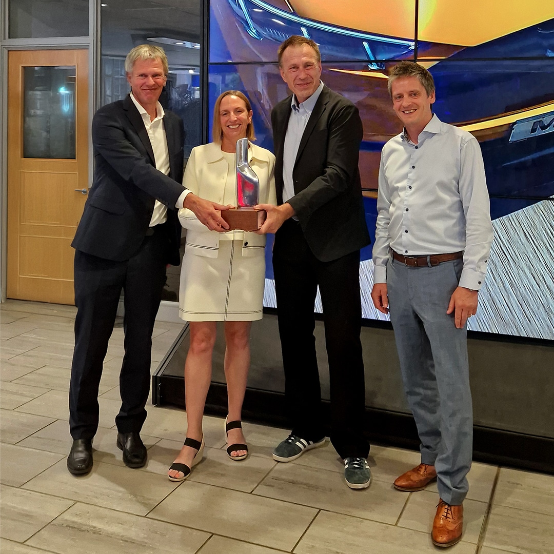 Mandy Dean presenting David Bussey, Paul Bussey and Scott Slater with the 2024 Ford Presidents Award for customer service and satisfaction